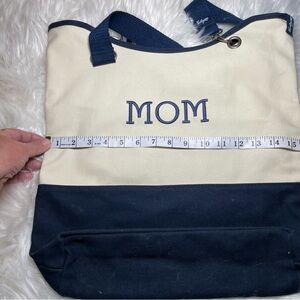 Thirty-one canvas tote embroidered with"MOM" on the front.